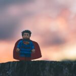 Lego superman stood on a log