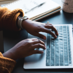 A person typing on a laptop