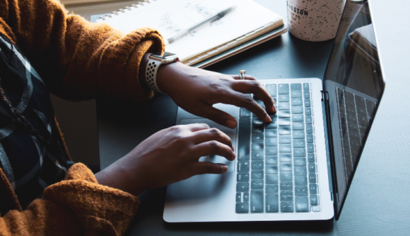 A person typing on a laptop