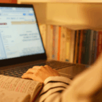 A student typing on a lapotp