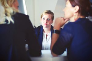 woman facing an interview panel