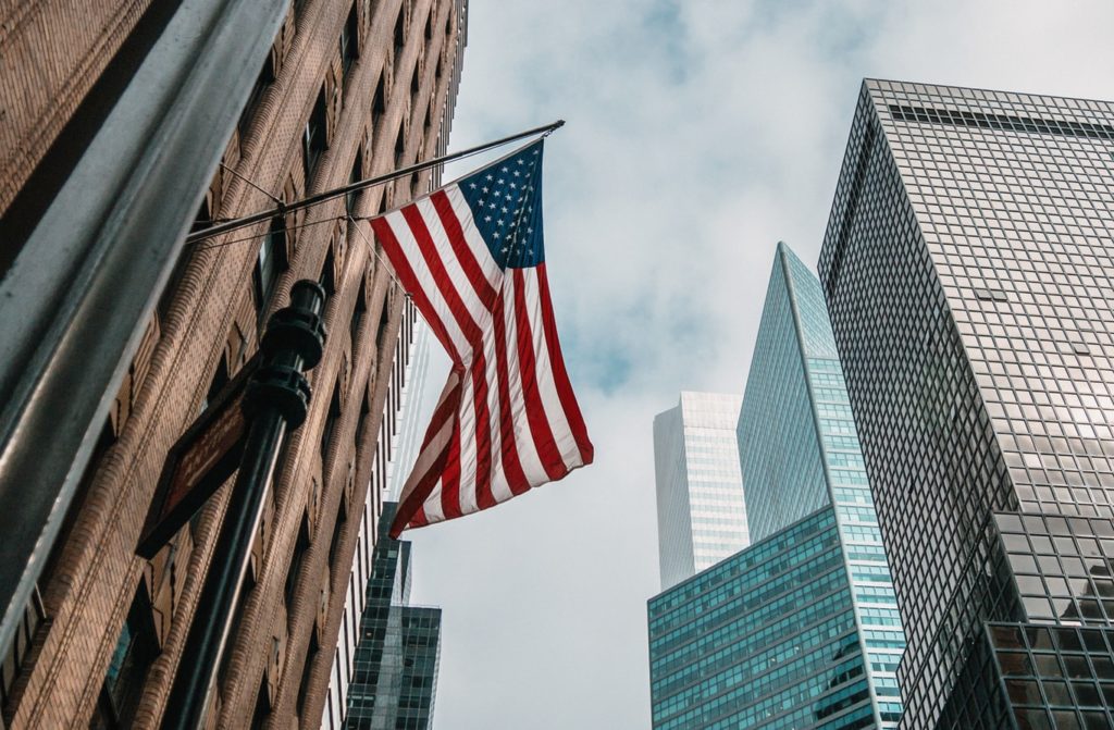 picture of skyscrapers and an american flag