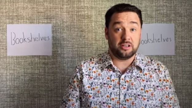 Jason Manford with a background of sheets of paper that say bookshelves