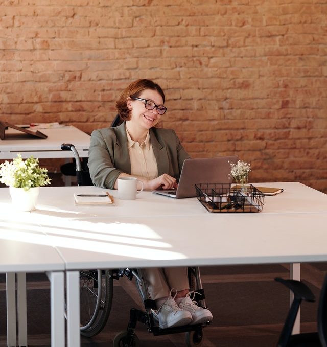 Person smiling while using laptop