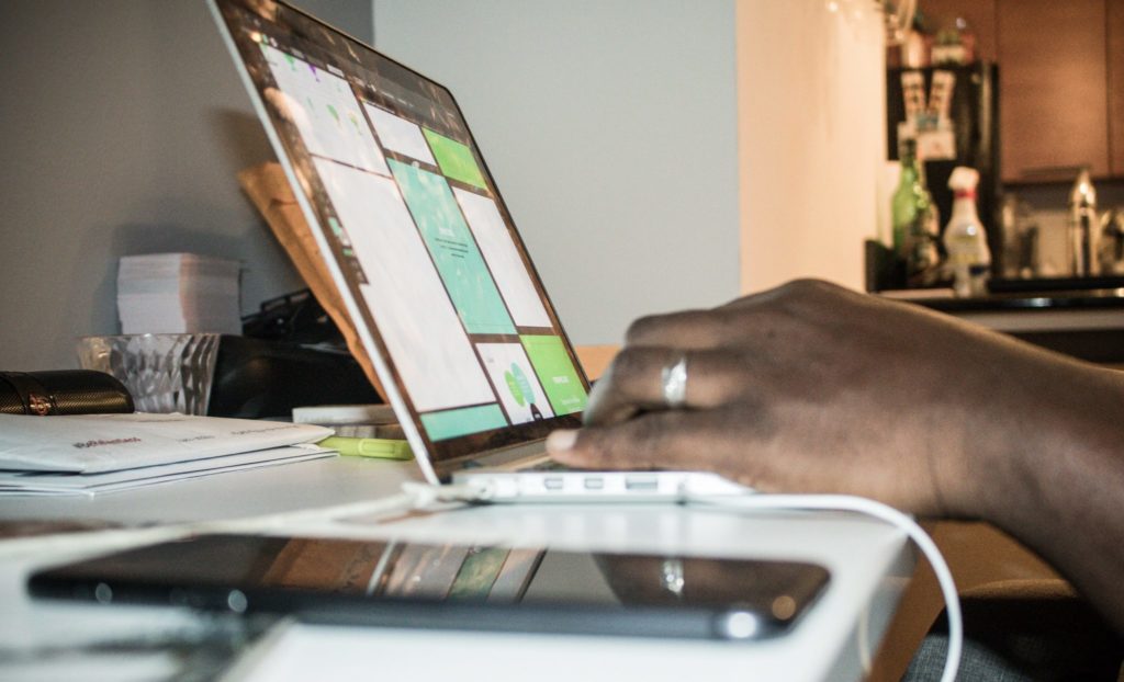 hand typing on a laptop in a home setting