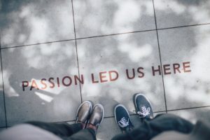 Two people standing over a quote saying "passion led us here".