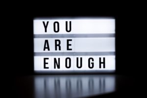 A sign saying "you are enough"