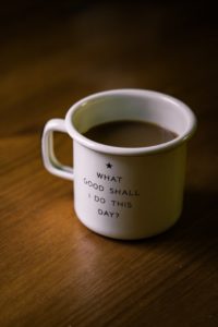 A white cup with writing on it saying "What good shall i do today?"