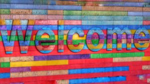 A colourful wall that says welcome