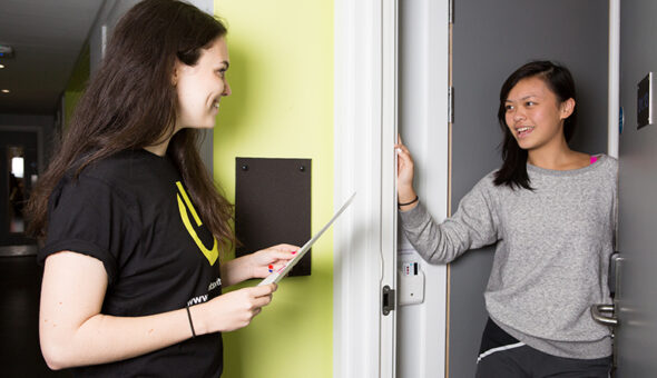 A student talk to a member of staff in student accommodation