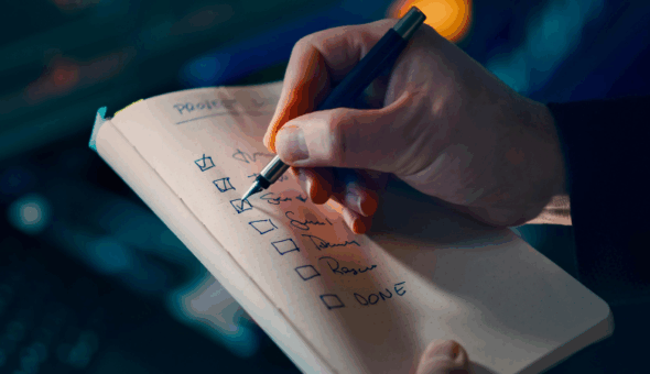 A photo of a person ticking boxes on a To Do list