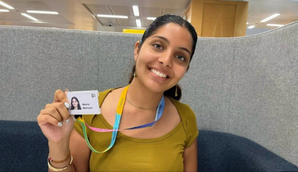 A photograph of Maaria Mamujee with her Aviva ID card