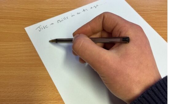 hand holding pen and writing notes