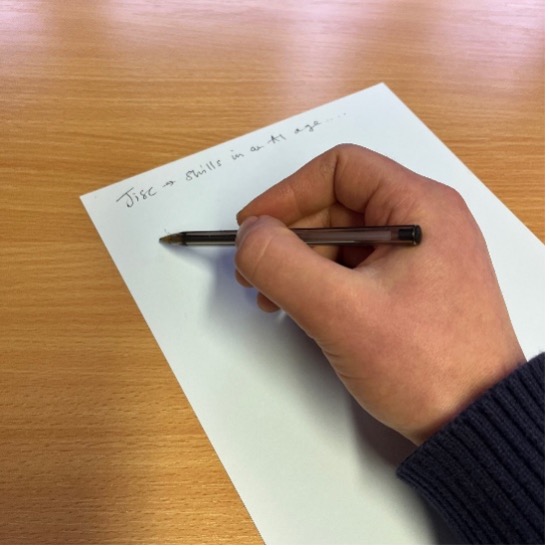 hand holding pen and writing notes