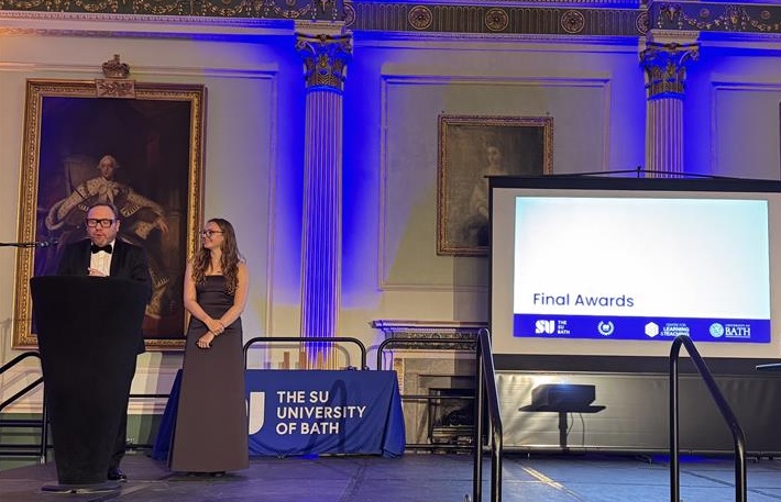Vice Chancellor and SU Officer (Education) on Stage with Award