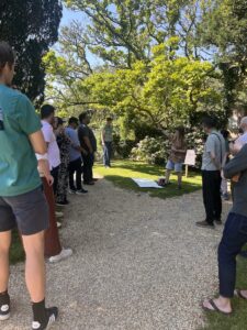 outside near trees, people stood up talking