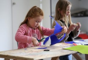 two children making paper-craft