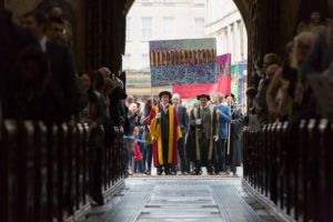 29095 25/10/2016 University of Bath 50th Anniversary Day. Procession with banners enters the abbey.