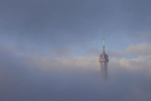 The Eiffel Tower is partially covered by an early morning fog in Paris, France, November 27, 2015 as the capital will host the World Climate Change Conference 2015 (COP21) from November 30 to December 11.     REUTERS/Philippe Wojazer