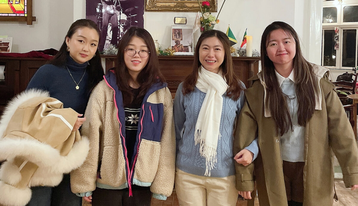 A group of people smiling while stood in a room in Fairfield House.