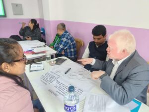 Multiple people having a conversation around a table.
