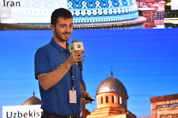 A student presents with microphone in hand