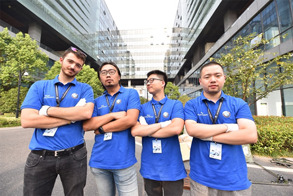 4 students stood in a line, facing camera