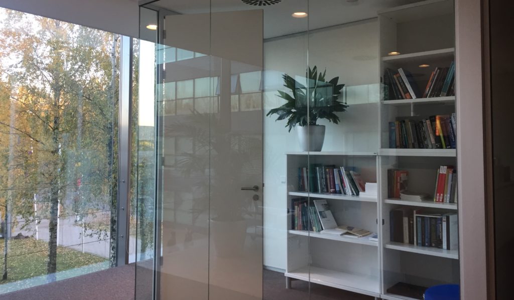 Glass windows facing the outside and bookshelves