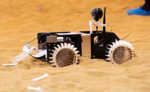 a close up of the Rover driving on sand