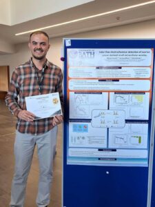 Prize winner Mehmet posing with his poster