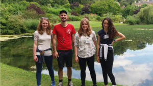 Alex and two other placement students in front of the main reflecting pool in Dyrham Park