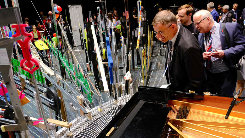 Two gentlemen appreciating the piano design