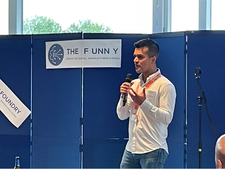 Co-Director of The Foundry, Bernardo Castro Dominguez on stage talking to the crowd.