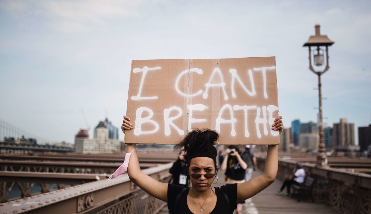 Picture of Black Woman Protesting with sign I can't breathe