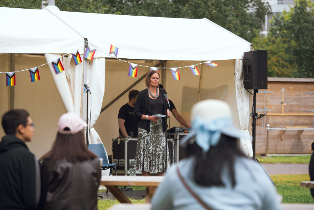 Pro-Vice-Chancellor of Student Experience, Cassie Wilson speaking to a crowd from beneath the marquee at Campus Pride 2022