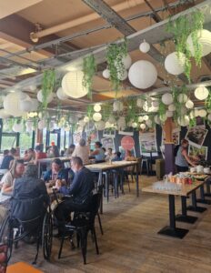 Groups of people talking at tables in the Parade cafe