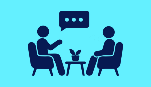 Two people sitting down chatting