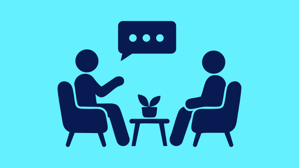 Two people sitting down chatting