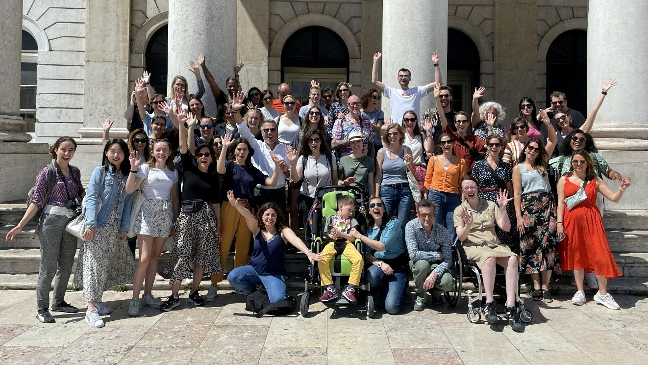 Group of people posing for a photo outside a building