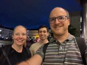 Selfie of three people in city scape