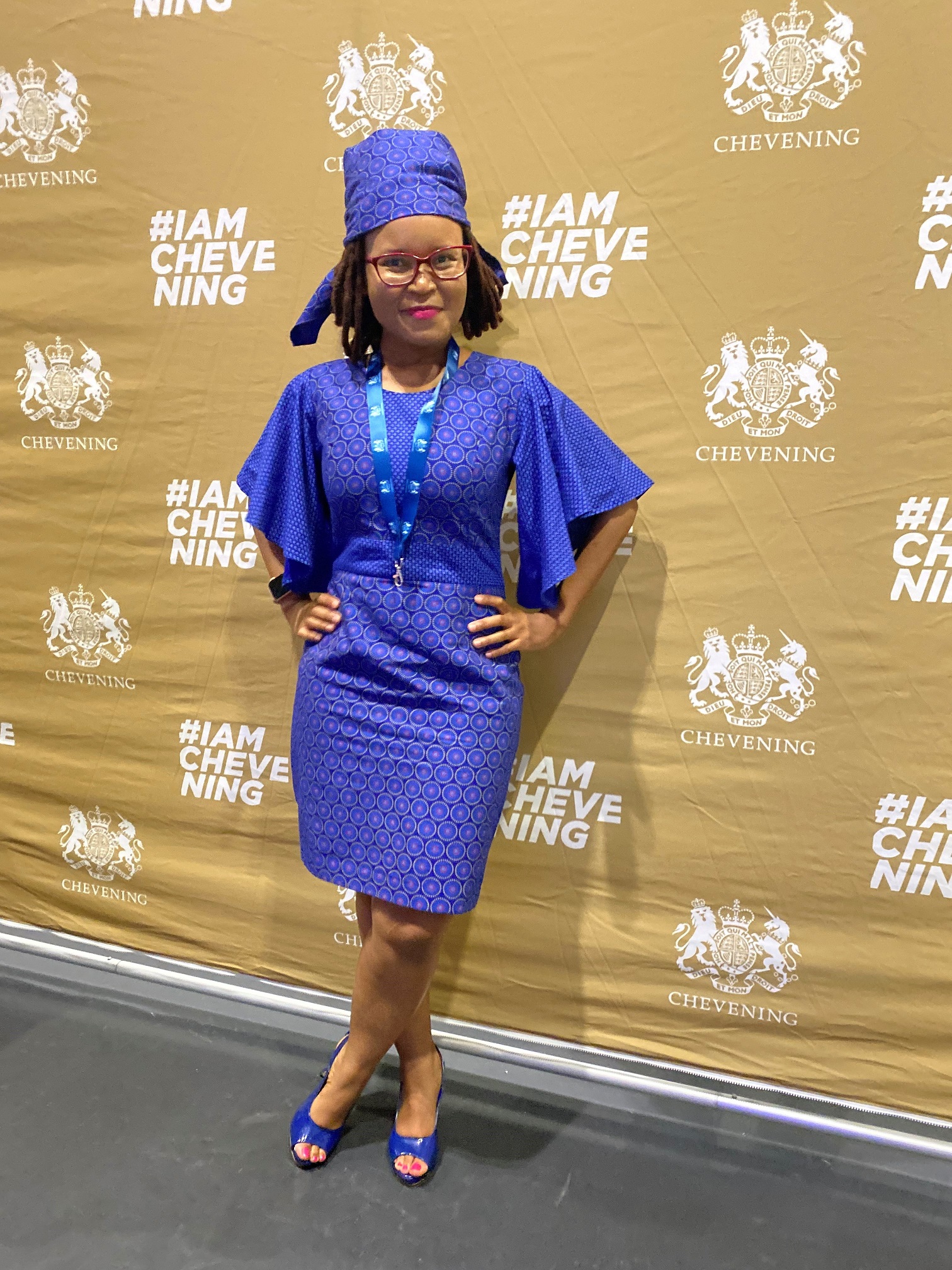 Suzan posing with the Chevening Scholar background