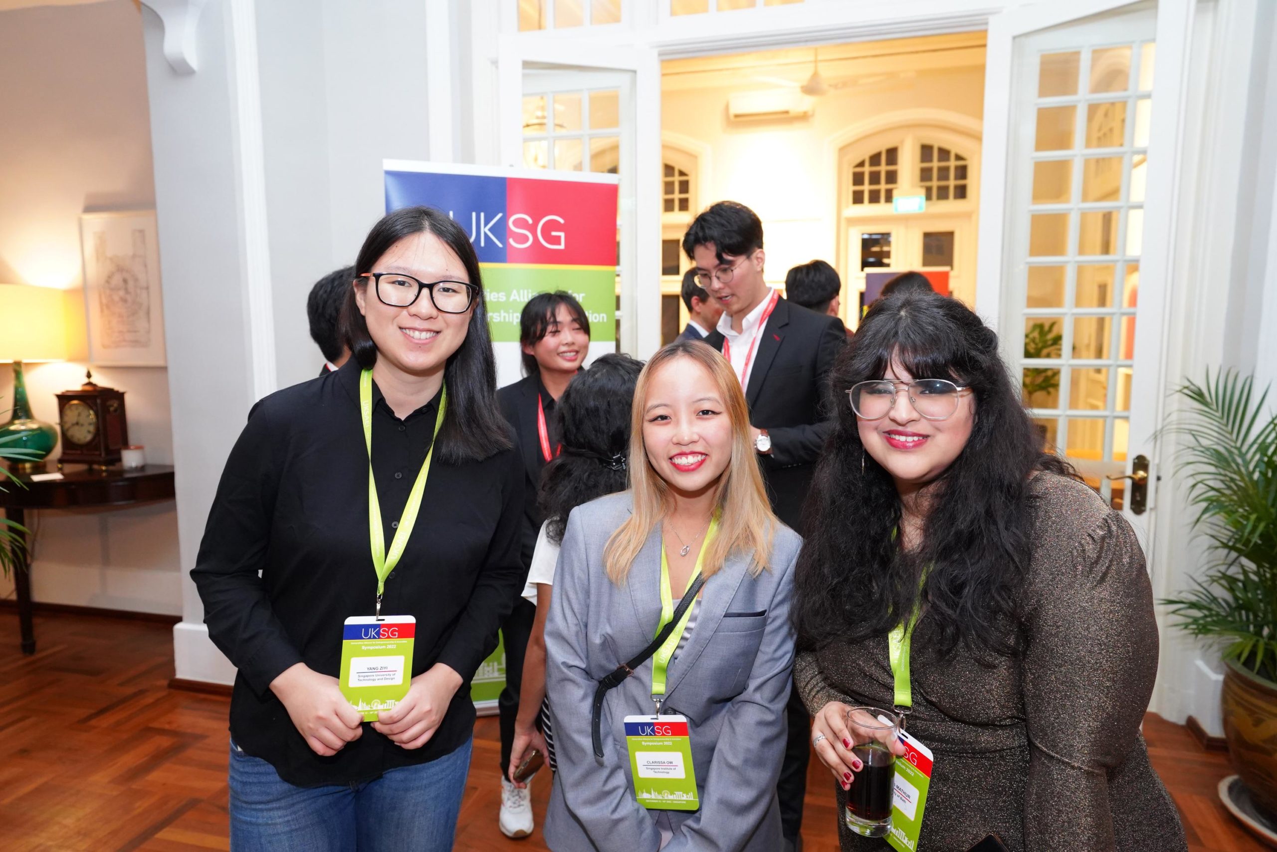 Three participants of the UKSAEI hackathon event posing during inaugural reception