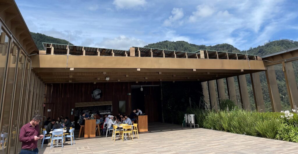 Students sit in a Rooftop cafe with flat solar panels 