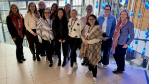A group of women stand in the atrium of a building