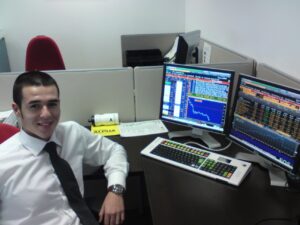 Martin smiling while sat down at his desk at BNY Mellon in 2010.