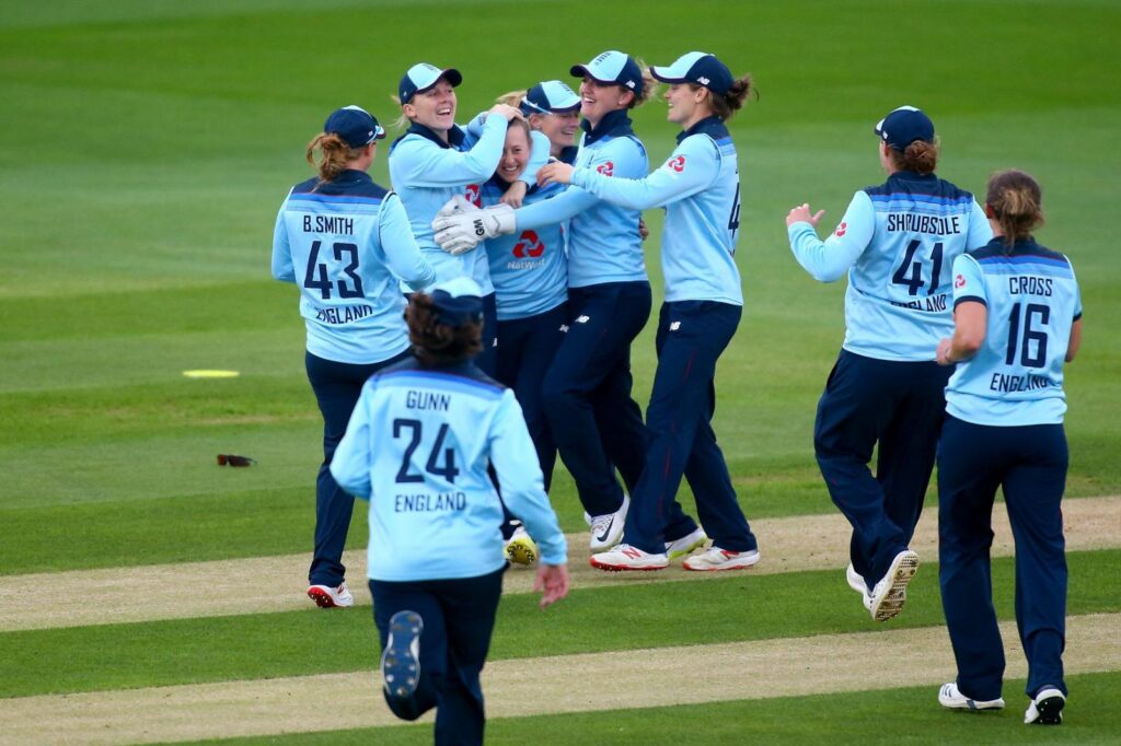 A group of female cricket players playing cricket