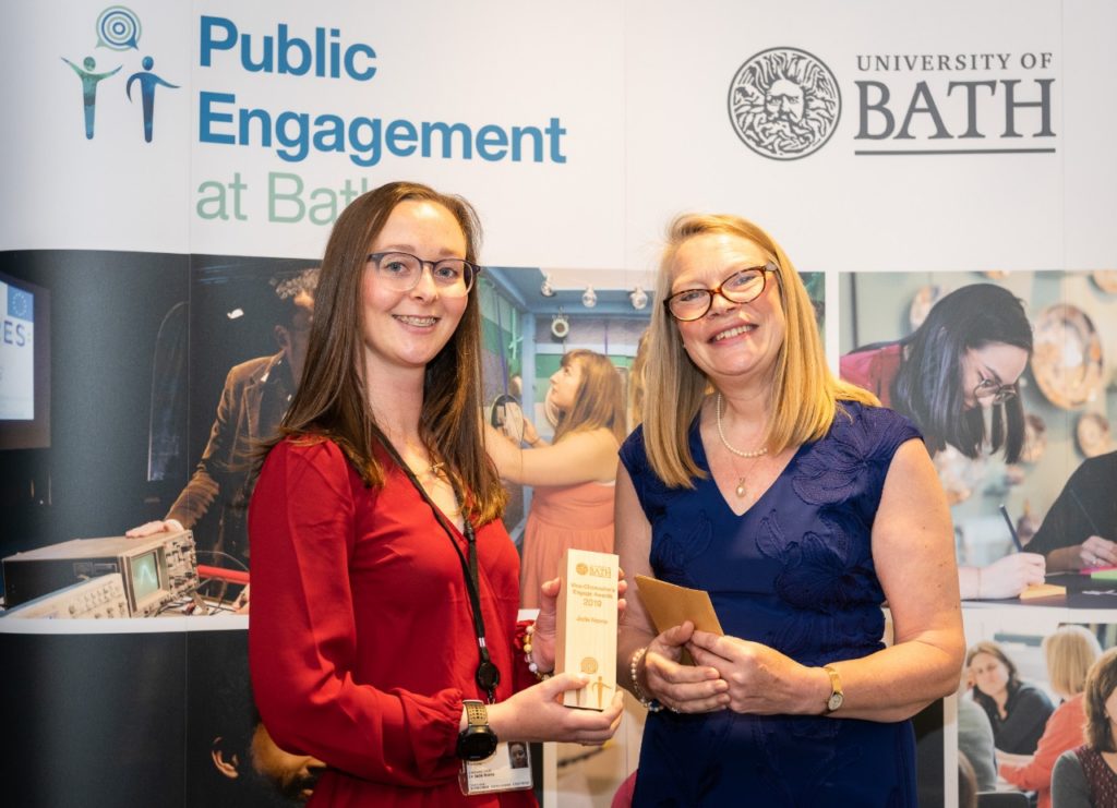 University of Bath researcher Jade Norris with Mrs. Margaret White on the award podium during the award presentation 