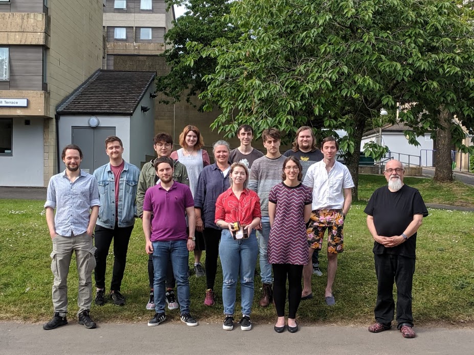 A group of people standing together and smiling.