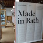 A view into an Exhibition at Holburne Museum. A large screen reads "Made in Bath