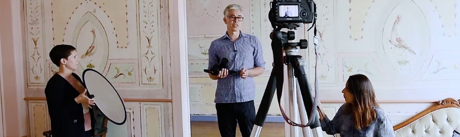 Filmmaker George Chan sets up a camera shot, aided with two women